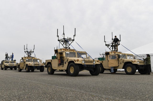 Humvee&#39;s sit on an airfield in preparation for a radio test during the Platoon Attack Experiment, May 3, 2021, on Joint Base McGuire-Dix-Lakehurst, N.J. The experiment focused on protected communications for tele-operating robotic combat vehicles under the Next Generation Combat Vehicles Cross-Functional Team’s (NGCV CFT) Manned-Unmanned Teaming (MUM-T) effort, which combines Soldiers, manned and unmanned air and ground vehicles, robotics and sensors to increase situational understanding, lethality and resiliency. 

