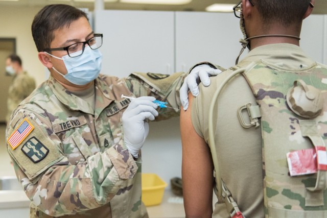 Staff Sgt. Eric Trevino, a medic at General Leonard Wood Army Community Hospital, administers a COVID-19 vaccine May 14 at Harper Clinic.