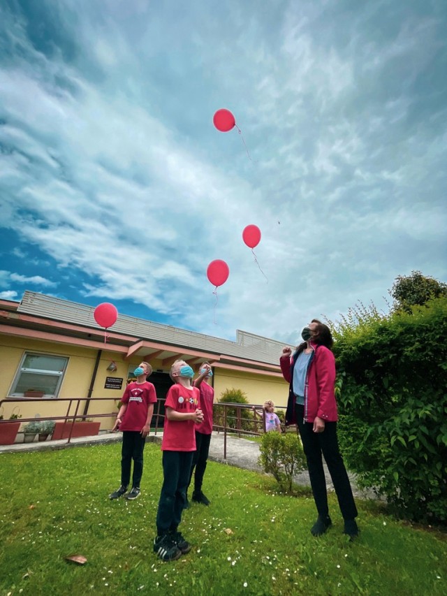 Brian, Matthew and Thomas, Jr. Ehler and widow Tatiana Soldatenko, let go of balloons to honor Thomas Ehler, in a bench commemoration ceremony May 17, 2021 at USAG Italy Army Community Service, Vicenza, Italy.