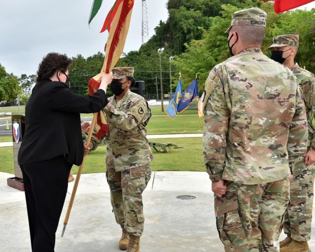 IMCOM – Readiness Director, Brenda Lee McCullough passes the garrison colors to incoming Garrison Commander, Col. Tomika M. Seaberry, signifying Seaberry’s assumption of command of Fort Buchanan.
