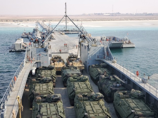 During Joint Logistics Over the Shore Native Fury 21, Soldiers from the 368th Seaport Operations Company alongside the U.S. Navy and Marines download Naval equipment for a training opportunity. The floating platform, or Trident pier, is used for...