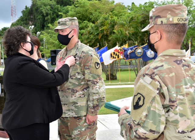 Director of Installation Management Command – Readiness, Ms. Brenda Lee McCullough pins Col. Corcoran with the Legion of Merit Medal “for exceptionally Meritorious Service as a Garrison Commander… having significantly  improved the readiness...
