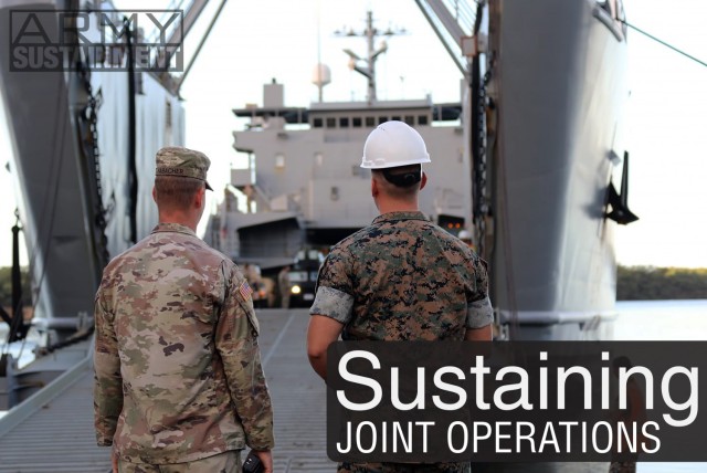 A Soldier and Marine observe Roll on/Roll off operations of U.S. Marine Corps equipment on an Army logistics support vessel in preparation for a recent movement within the Hawaiian Islands. Providing support to other services is a part of what the Army brings to the joint fight. 