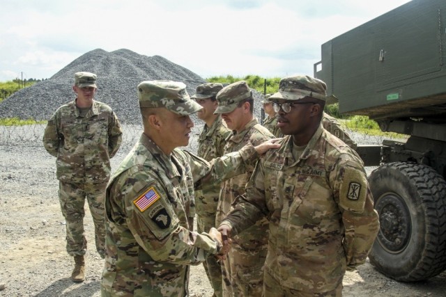 Maj. Gen. Viet X. Luong, U.S. Army Japan commander, gives encouragement to Staff Sgt. Torrance Salter while conducting battlefield circulation on Sept. 16, 2019, at Oyanohara Training Area, Japan. Luong is the first Vietnam-born service member to reach the general officer rank.
