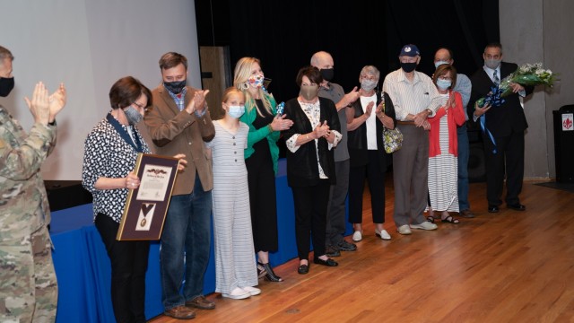 Stickle shows her surprise as several of her family members appear on stage when her Order of the White Plume award was being announced.