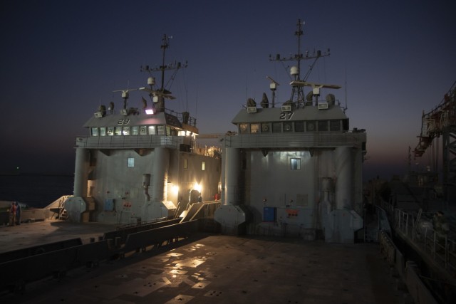 Two Army Landing Craft Utilities (LCU) are staged at the Kuwaiti Naval Base, Kuwait, before transporting to their new area of operations on Oct. 7, 2020. LCU&#39;s are capable of transporting wheeled or tracked vehicles and personnel from battle ships to land. (Photo by Staff Sgt. Christopher Osburn)