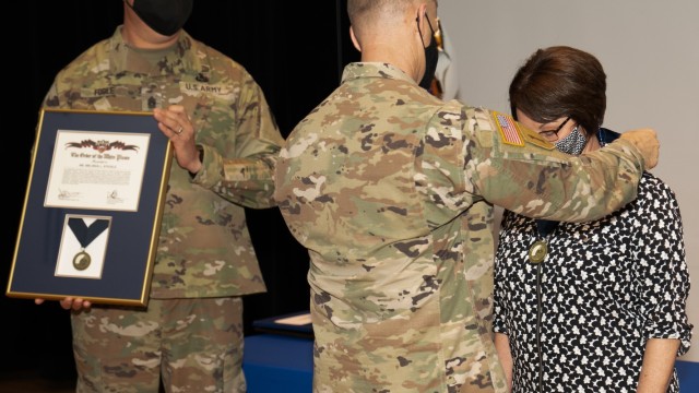 Stickle shows her surprise as several of her family members appear on stage when her Order of the White Plume award was being announced.