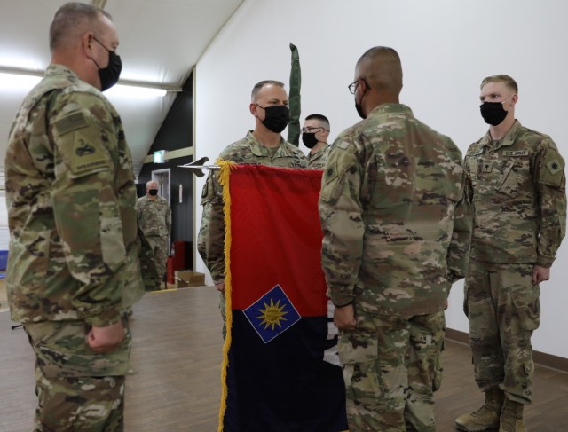 Task Force Phoenix Command Chief Warrant Officer 5 Rich Huber, Commander Col. Alan Gronewold and Command Sgt. Maj. Refugio Rosas uncase the 40th Combat Aviation Brigade&#39;s colors during a Transfer of Authority ceremony at Camp Buehring, Kuwait....