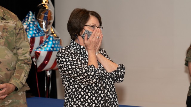 Stickle shows her surprise as several of her family members appear on stage when her Order of the White Plume award was being announced.