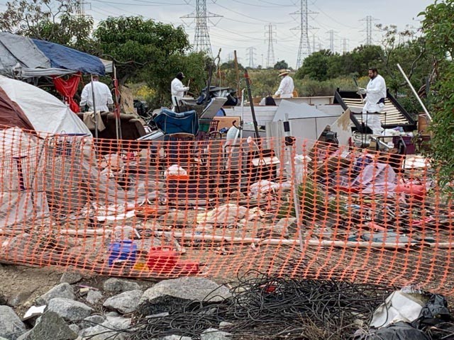 A cleanup crew from the U.S. Army Corps of Engineers Los Angeles District arrives at one of the abandonded campsites immediately below the Santa Fe Dam, May 10, 2021. The dam and Santa Fe Recreation Area adjacent to the 605 Freeway are maintained...