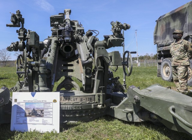 Command Sgt. Maj. Samuel Zoker, senior enlisted advisor, 41st Field Artillery Brigade, stands next to 2nd Cavalry Regiment’s 155mm lightweight towed Howitzer on display as part of Dynamic Front 21 Academics Day, at Vilseck Army Air Field,...