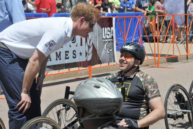 Prince Harry offers words of encouragement and jokes around with then Army Lt. Col. Danny Dudek before the start of the 2013 Warrior Games recumbent bike cycling competition near the U.S. Air Force Academy in Colorado Springs, Colo., May 11. Dudek served almost 30 years in the Army, retiring as a colonel in February of this year.