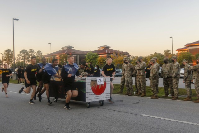 Dogface Soldiers of Special Troops Battalion, 3rd Sustainment Brigade, 3rd Infantry Division push their decorated bed towards the finish line during the bed race at Fort Stewart, Georgia, May 17, 2021. The bed race kicks off this Marne Week,...