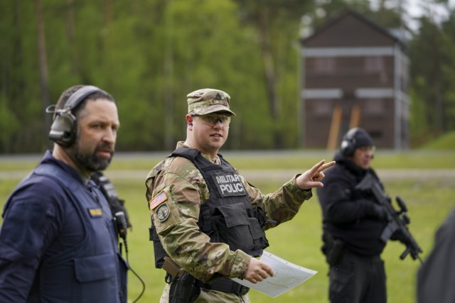 Hubert Beer, Upper Palatinate Polizei Weapons and Tactics Instructor (left), and USAG Bavaria DES Staff Sgt. Simonis (right), run participants through the Law Enforcement Weapons Training and Qualification rifle event. 