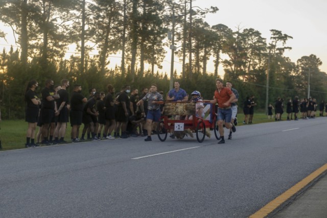 Dogface Soldiers of the 1st Battalion, 9th Field Artillery Regiment, 2nd Armored Brigade Combat Team, 3rd Infantry Division push their decorated bed towards the finish line during the bed race at Fort Stewart, Georgia, May 17, 2021. The bed race...