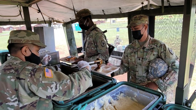 Culinary Specialists assigned to Headquarters and Headquarters Company, 311th Signal Command (Theater) serve a welcome hot meal to fellow Army Reserve Soldiers in and beside their Mobile Kitchen Trailer during range qualification operations at...