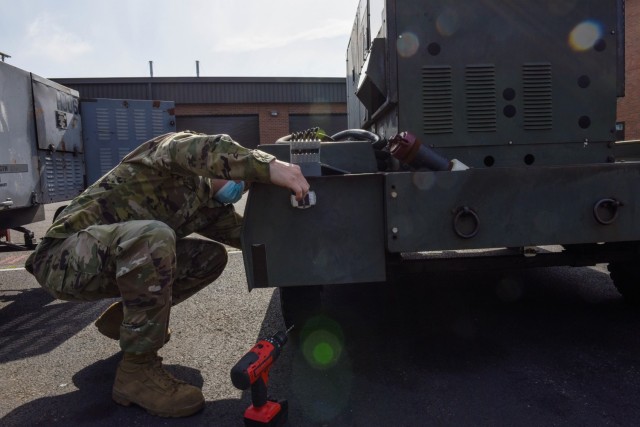 U.S. Air Force Tech. Sgt. Harley Hall, 446th Maintenance Squadron Aerospace Ground Equipment craftsman, installs a GPS tracking device to an AGE mobile generator on Joint Base Lewis-McChord, Washington, May 13, 2021. The new GPS trackers are...