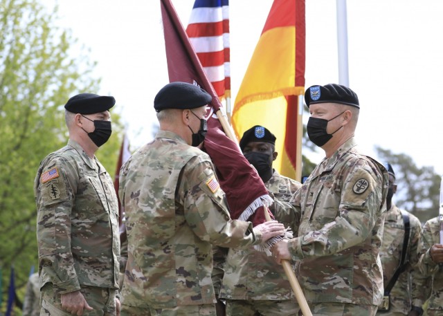 LANDSTUHL, Germany -- (From left) U.S. Army Col. Andrew L. Landers watches as U.S. Army Brig. Gen. Mark W. Thompson, commanding general, Regional Health Command Europe, receives the Landstuhl Regional Medical Center unit colors from U.S. Army Col. Michael A. Weber during a change of command ceremony where Weber relinquished command of LRMC to Landers at LRMC, May 20. Landstuhl Regional Medical Center is the largest American military medical center outside of the United States and plays a strategic role as the sole evacuation and tertiary referral center for five combatant commands.