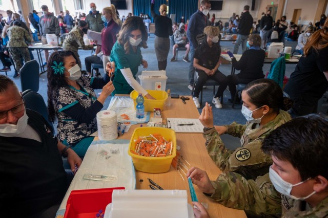 Medics from Stuttgart Army Health Clinic, prepare vials of COVID-19 vaccines for a vaccine drive aimed at 12 to 17-year-olds on Patch Barracks, near Stuttgart, Germany, May 22, 2021.