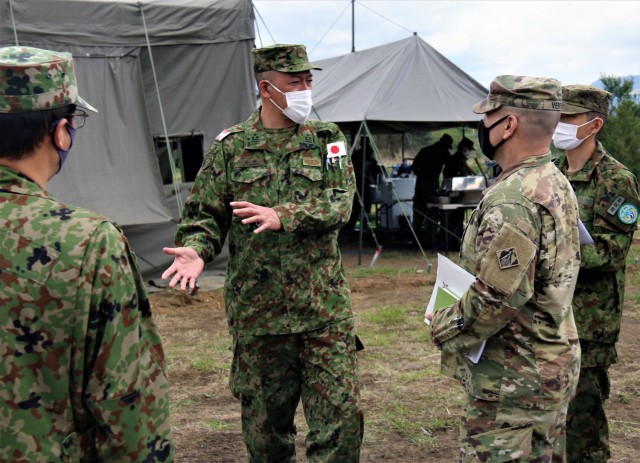 Col. Yamada Norikazu, Central Readiness Regiment commanding officer, JGSDF, shows Col. Thomas J. Verell, Jr., Japan Engineer District commander, US Army, a tour of the forward operating base that his team has constructed. The two leaders talked...