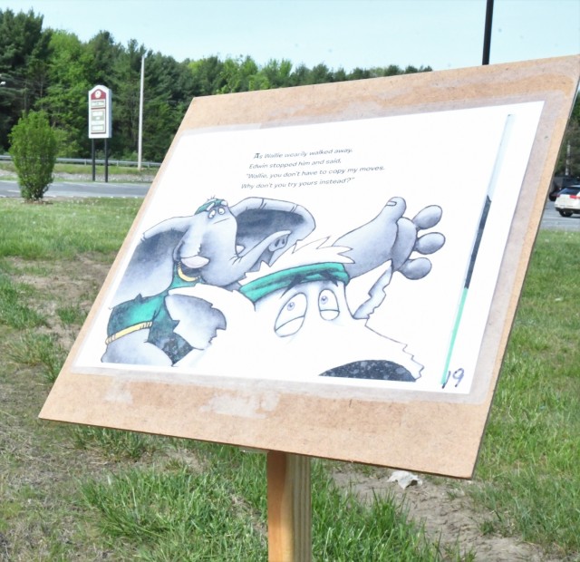 The Story Walk at Robert C. McEwen Library combined reading and exercise for Fort Drum youth on May 21, with members of the Better Opportunities for Single Soldiers program assisting children along the way. (Photo by Mike Strasser, Fort Drum...