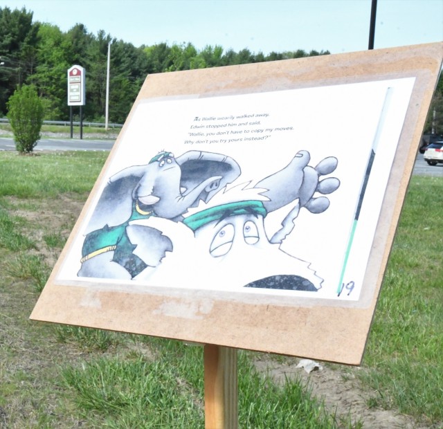 The Story Walk at Robert C. McEwen Library combined reading and exercise for Fort Drum youth on May 21, with members of the Better Opportunities for Single Soldiers program assisting children along the way. (Photo by Mike Strasser, Fort Drum Garrison Public Affairs)