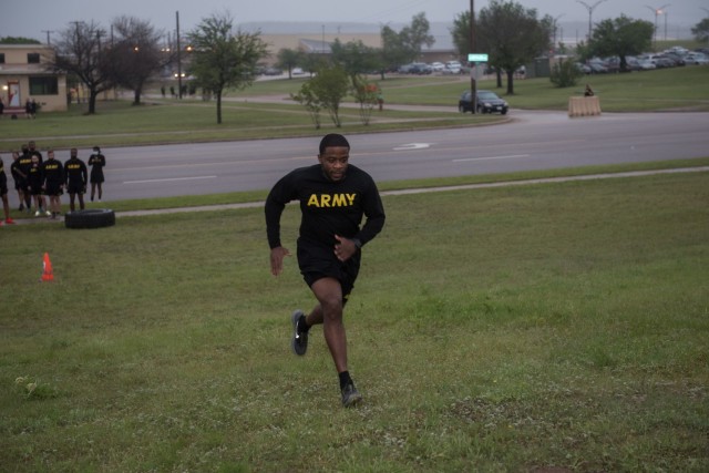 Company first sergeant, 1st Sgt. Richard Gaines II, conducts physical readiness training with candidates and cadre during a rainy, Ft. Hood morning.  Cadre are an important part of any training experience, which is why only the best-of-the-best are used at the 13th Expeditionary Sustainment Command’s newest People First initiative. (U.S. Army photo by Sgt. 1st Class Kelvin Ringold)
