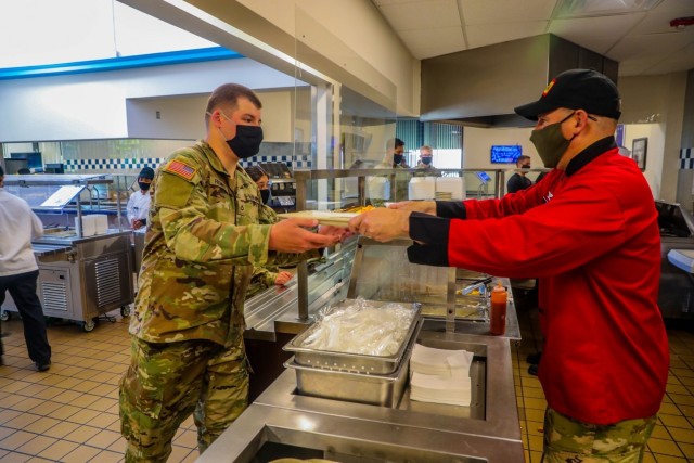Col. Robert Born, commander, Brigade Combat Team “Bastogne”, 101st Airborne Division (Air Assault), right, serves a breakfast plate to Pfc. Alec Fromherz, infantryman, ABU Company, 1st Battalion 327th Infantry Regiment “Above the Rest,” left, during breakfast service May 14 in Snipes Dining Facility on Fort Campbell, Kentucky. Culinary Experts in Snipes Dining Facility prepare meals for over 3,000 Soldiers in the brigade every day to ensure the readiness, sustainment and readiness of the force.