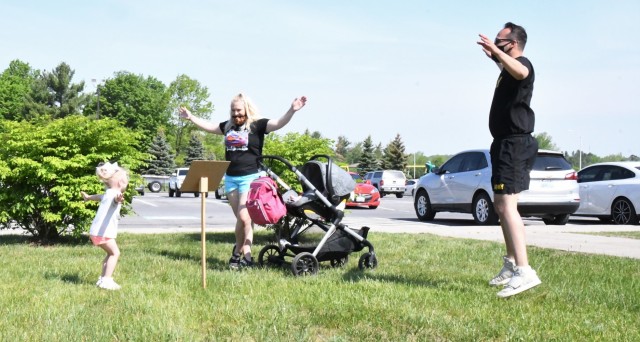 The Story Walk at Robert C. McEwen Library combined reading and exercise for Fort Drum youth on May 21, with members of the Better Opportunities for Single Soldiers program assisting children along the way. (Photo by Mike Strasser, Fort Drum Garrison Public Affairs)