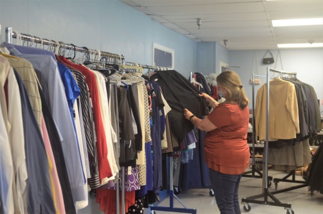 Hillary Brewer, Fort Campbell Armed Services YMCA education coordinator, organizes clothing May 13 at the ASYMCA. The USO, Spouse Employment Center and ASYMCA have partnered to create a clothing voucher program that affords Fort Campbell Soldiers...