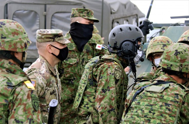 Col. Yamada Norikazu, Central Readiness Regiment commanding officer, JGSDF, shows Col. Thomas J. Verell, Jr., Japan Engineer District commander, US Army, how the elite unit’s explosive ordinance disposal team is adept at using drone technology...