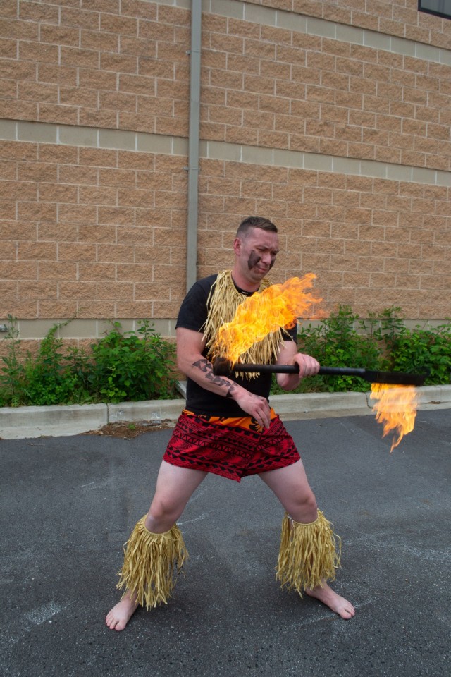 Spc. Kinion Carrol, a soldier assigned to Headquarters, Headquarters Company, U.S. Army Reserve Legal Command from Waianae, Hawaii, demonstrates his knowledge and skill with the fire knife on Sunday, May 16, 2021.  
...