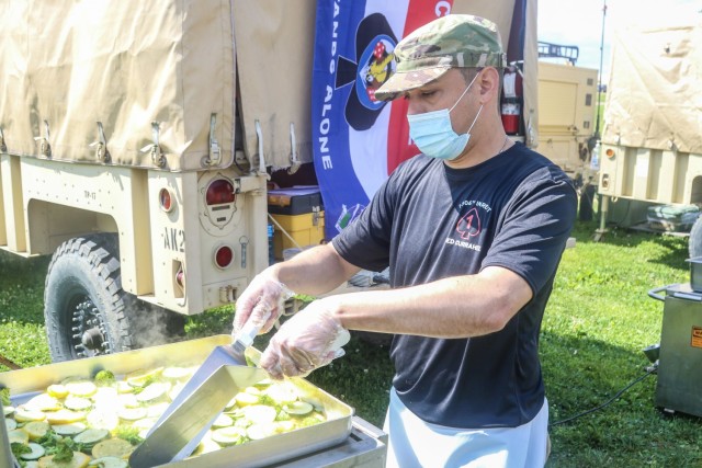 U.S. Army Spc. Nicholas Barry, culinary specialist, J Company, 1st Battalion, 506th Infantry Regiment “Red Currahee,” 1st Brigade Combat Team, 101st Airborne Division (Air Assault), cooks squash and zucchini at the Culinary Expert Competition May 5 in front of  Snipes Dining Facility on Fort Campbell, Ky. Bastogne Week is a week-long competitive event building esprit de corps and pride within the unit.  (U.S. Army photo by Maj. Vonnie Wright, 1st Brigade Combat Team Public Affairs)