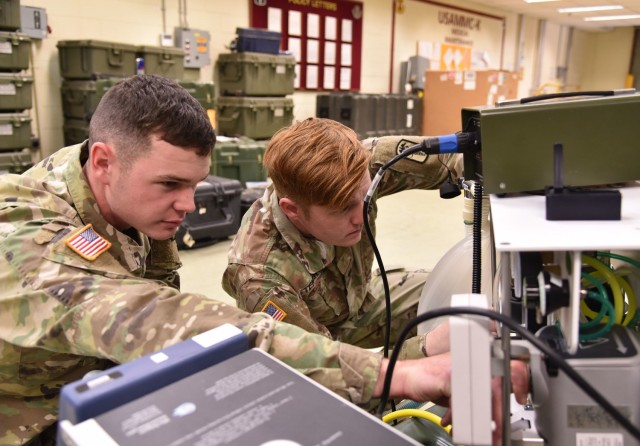 Soldiers assigned in support of the U.S. Army Medical Materiel Center-Korea perform maintenance on a medical device.