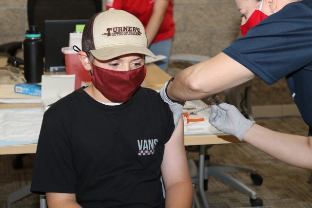 Andrew Friday, 12, son of Sgt. 1st Class Joshua Friday, an observer, coach and trainer with Cobra Team, Operations Group, receives the Pfizer COVID-19 vaccine May 15 at the Dr. Mary E. Walker Center on Fort Irwin, Calif. Andrew was the second...