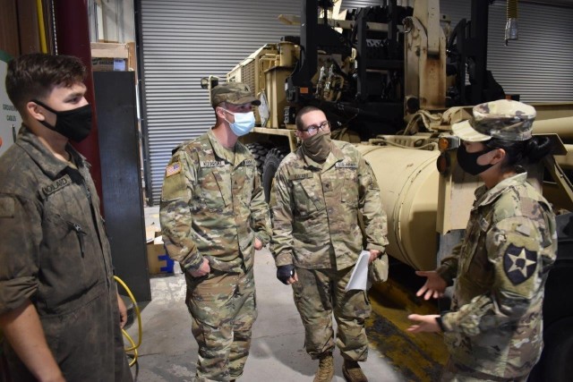 U.S. Army 2nd Lt. Pauline Heng (right), previously a mechanic in 1-2 Stryker Brigade, visits with her fellow mechanics in the 1-14 Cav. motor pool after returning as a commissioned officer following Officer Candidate School. (Photo Credit: Courtesy of 2nd Lt. Pauline Heng)