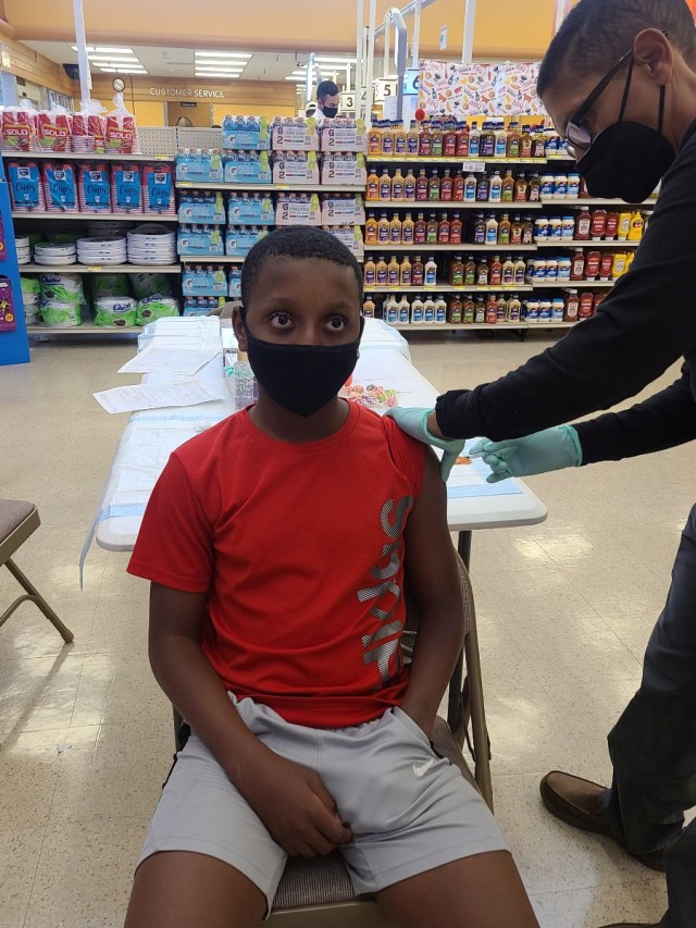 Nicholas Brunson, 13, son of Col. LaHavie Brunson, the 916th Sustainment Brigade commander, receives the Pfizer COVID-19 vaccine May 16 at the commissary on Fort Irwin, Calif. Weed Army Community Hospital held weekend vaccination events at the...