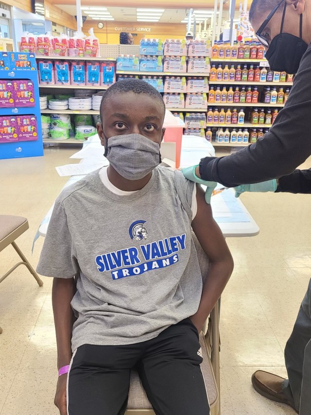 Alexander Brunson, 14, son of Col. LaHavie Brunson, the 916th Sustainment Brigade commander, receives the Pfizer COVID-19 vaccine May 16 at the commissary on Fort Irwin, Calif. Weed Army Community Hospital held weekend vaccination events at the...