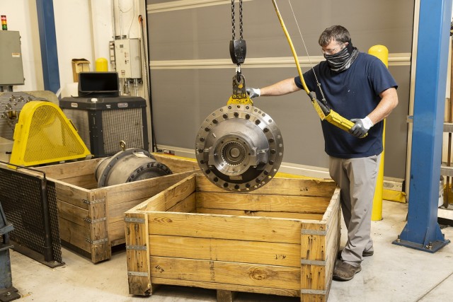 Tristan Homesley, a heavy mobile equipment mechanic, inspects an overhauled final drive for an M1 Abrams combat vehicle.