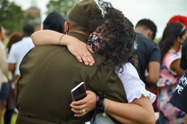 Pvt. Christian Jimenez gets a hug from his mother, Yesnia Soloria, after graduating from One Station Unit Training with Company B, 795th Military Police Battalion, May 20 on Gammon Field. Family and friends are once again being invited to attend...