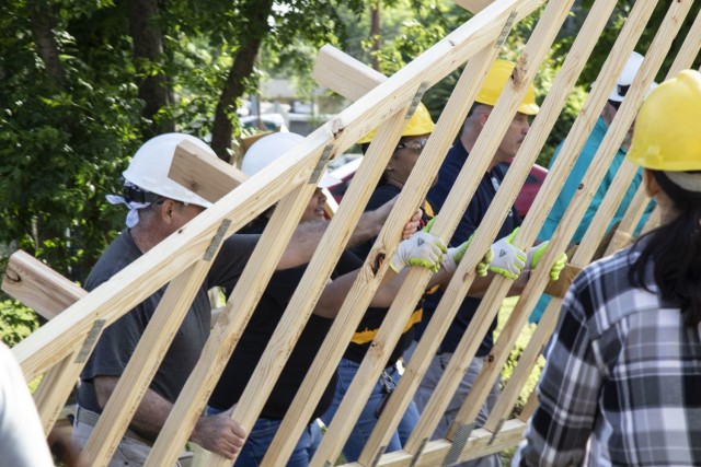 U.S. Army Reserve Soldiers assigned to the Mobilization Demobilization Operations Center (MDOC) from the 2-381st Training Support Battalion, 120th Infantry Brigade, Division West, along with other volunteers, assist with moving lumber during a Habitat for Humanity housing project in Waco, Texas, May 16, 2021.  The participants from the MDOC team used this volunteering opportunity to frame a creative way for team building and leadership development, while also supporting the local community. (U.S. Army Photo by Staff Sgt. Erick Yates)
