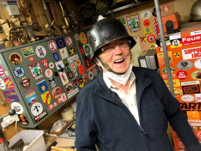 92-year-old Horst Teumer laughs as he shows off the original firefighting helmet he wore when he joined the Baumholder Military Community Fire Department in 1954. Teumer eventually became the Fire Chief on the Baumholder installation and retired...