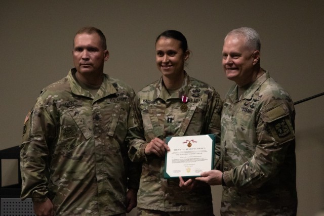 Capt. Michelle Hauprich is awarded the Meritorious Service Medal by Maj. Gen. John Evans at the Headquarters & Headquarters Detachment  Change of Command Ceremony at Fort Knox, KY, on May 26, 2021.