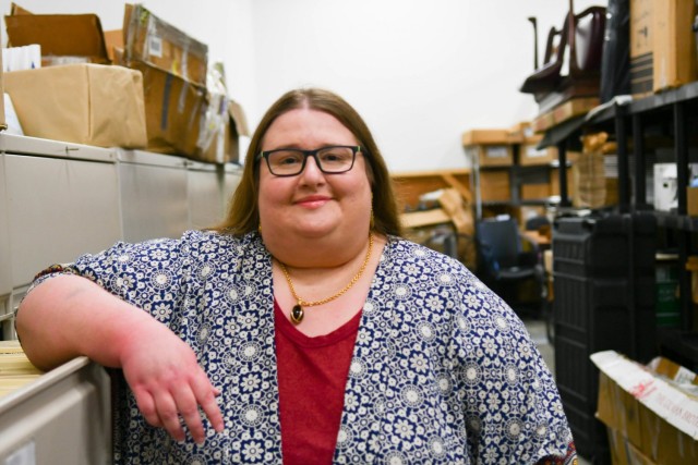 Dr. Lauren Hammersen, Military Surface Deployment and Distribution Command historian, poses for a photo while conducting inventory of the command's historical artifacts May 26, 2021.