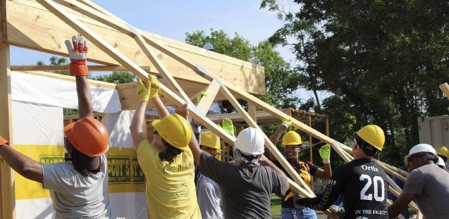 U.S. Army Reserve Soldiers assigned to the Mobilization Demobilization Operations Center (MDOC) from the 
2-381st Training Support Battalion, 120th Infantry Brigade, Division West, along with other volunteers, assist with lifting the roof framing on a new house construction during a Habitat for Humanity housing project in Waco, Texas May 16, 2021. The participants form the MDOC team used this volunteer opportunity as a chance to frame a creative way for team and leadership building while also supporting the local community. 
(Courtesy Photo)