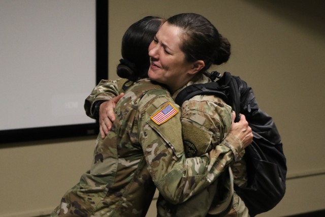 Capt. Ciara Stevenson hugs her former boss Capt. Michelle Hauprich at the Headquarters & Headquarters Detachment Change of Command Ceremony at Fort Knox, KY, on May 26, 2021.
