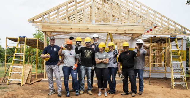 U.S. Army Reserve Soldiers assigned to the Mobilization Demobilization Operations Center (MDOC) from the 
2-381st Training Support Battalion, 120th Infantry Brigade, Division West, stand together for a group photo after completing the roof framing on a new house construction during a Habitat for Humanity housing project in Waco, Texas, May 16, 2021.  The participants form the MDOC team used this volunteer opportunity to frame a creative way for team and leadership building while also supporting the local community. (U.S. Army Photo by Staff Sgt. Erick Yates)