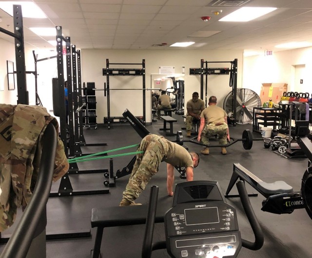 In February 2021, 1st Lt. Andrew Schwartz, physical therapist at the Fort Bragg Soldier Recovery Unit, North Carolina, (left) led a stretching exercise with SRU Soldiers and cadre. (Photo courtesy of Dean Bissey)
