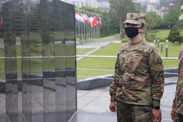 Spc. Rosemarie Hood, 25th Transportation Battalion, 19th Expeditionary Sustainment Command, reads the names inscribed on the Wall of Remembrance at United Nations Memorial Cemetery in Korea, May 18, 2021. Soldiers from 19th ESC visited the memorial as part of a spiritual resilience training event organized by the 19th ESC Chaplain's Office.