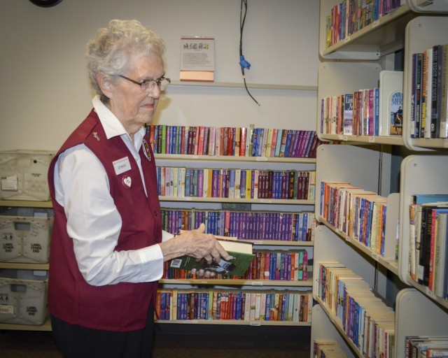 Joy Moore, volunteer, sorts books in the Patient Library at Brooke Army Medical Center, Fort Sam Houston, Texas, May 27, 2021. Moore is retiring after 36 years of volunteer service. (U.S. Army photo by Lori Newman)